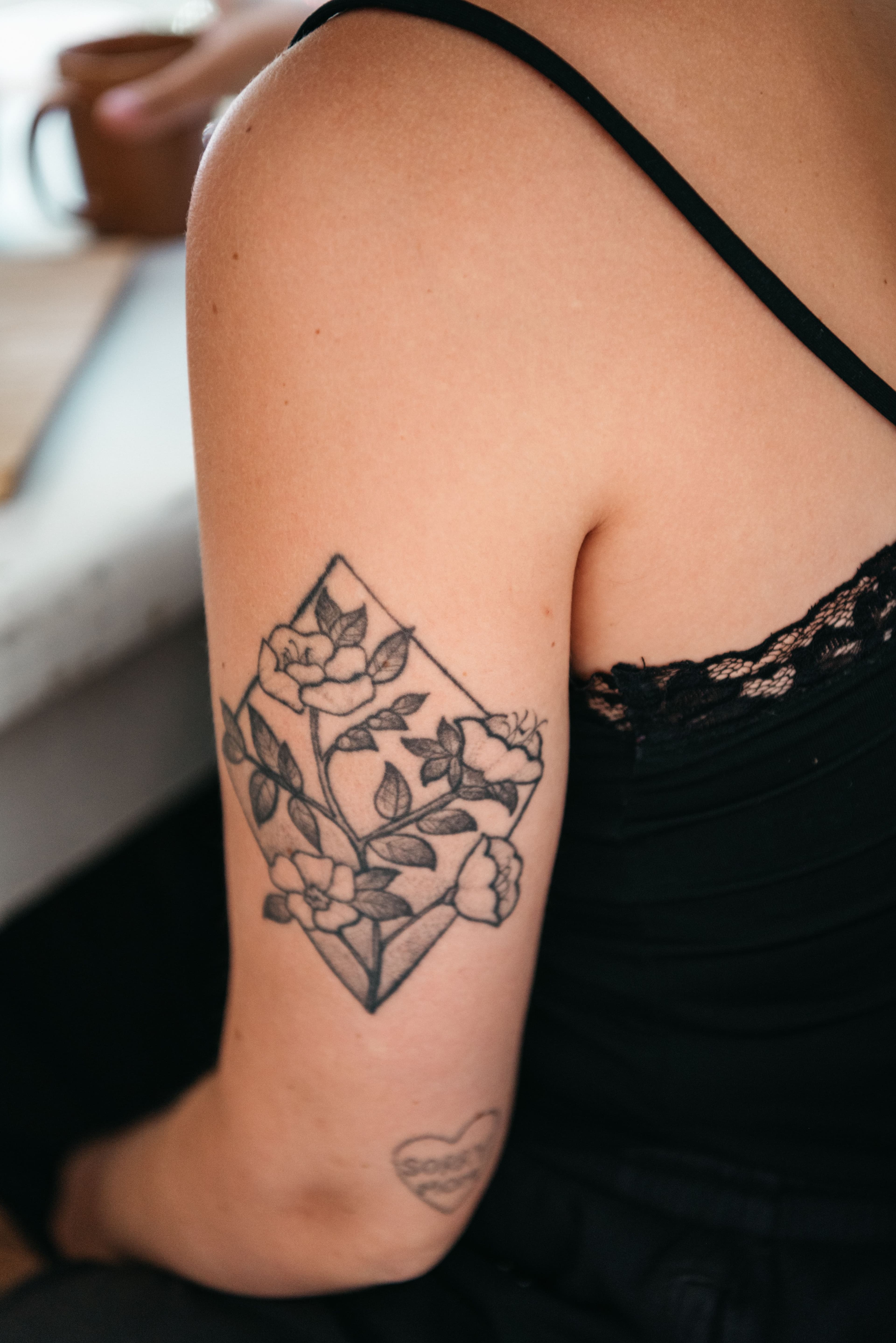 Close-up of a floral tattoo on an upper arm