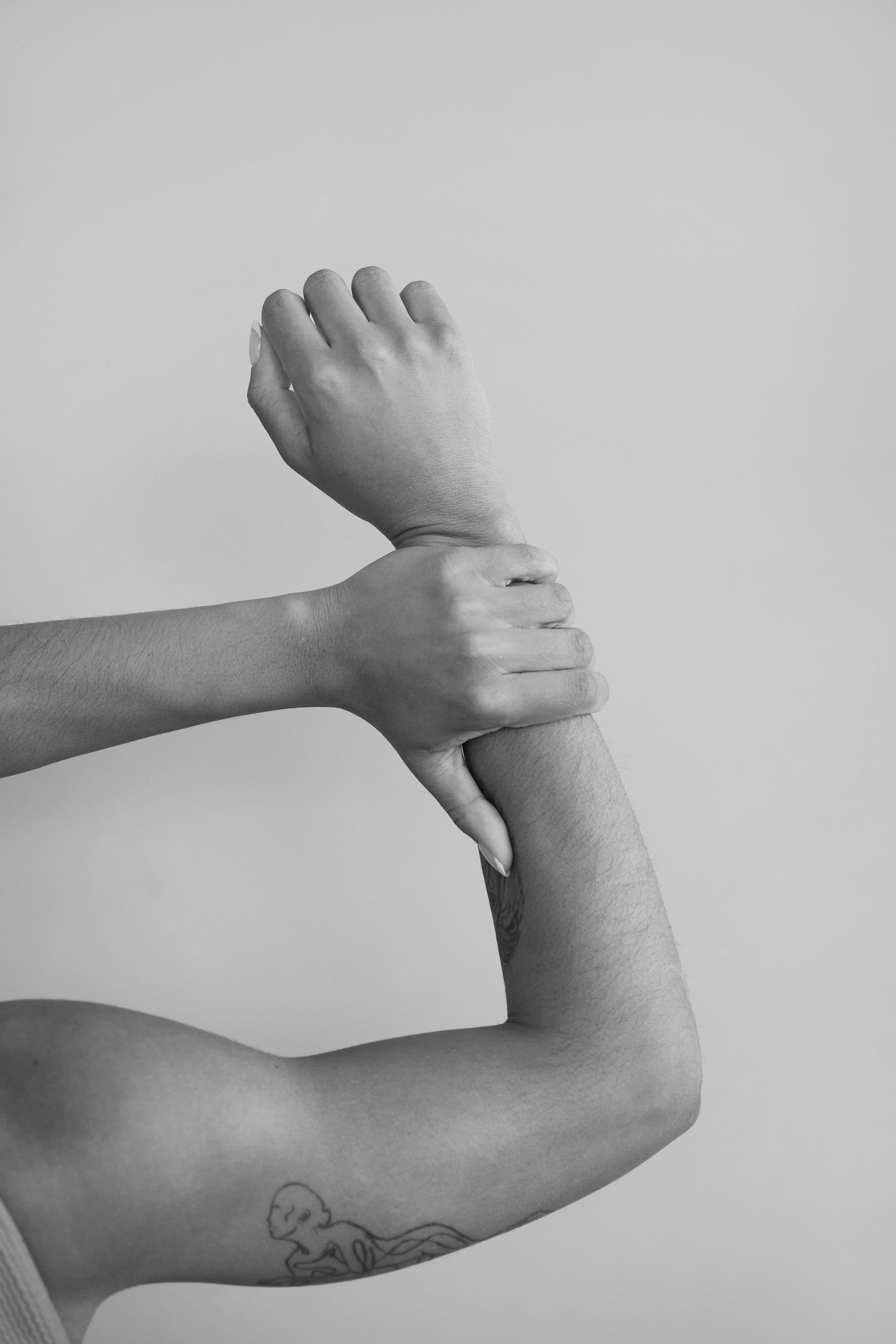 Person holding their wrist to show a tattoo placement